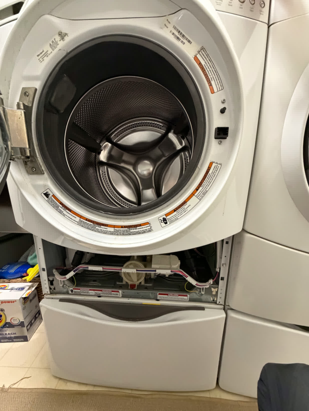 Open front-load washing machine after service and reassembly check