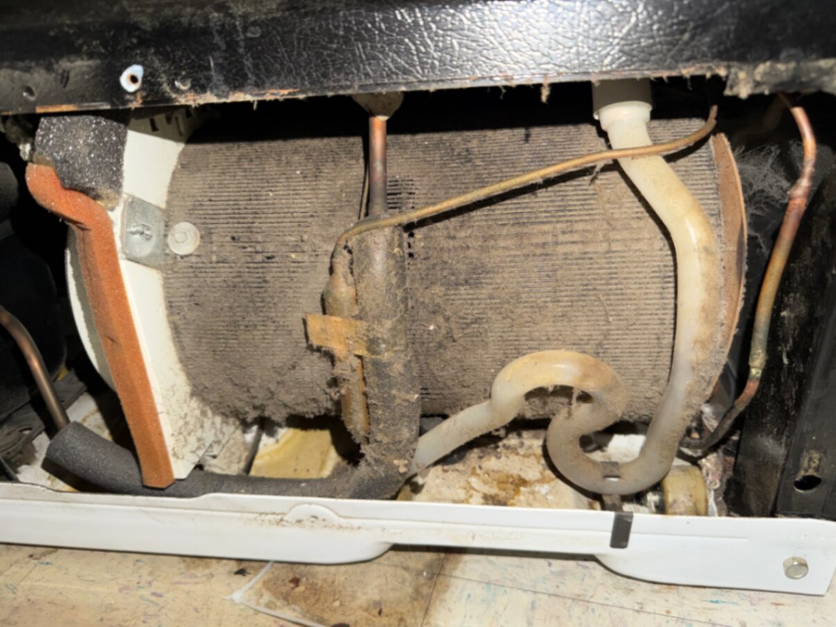 Refrigerator condenser coil cleaning for cooling restoration