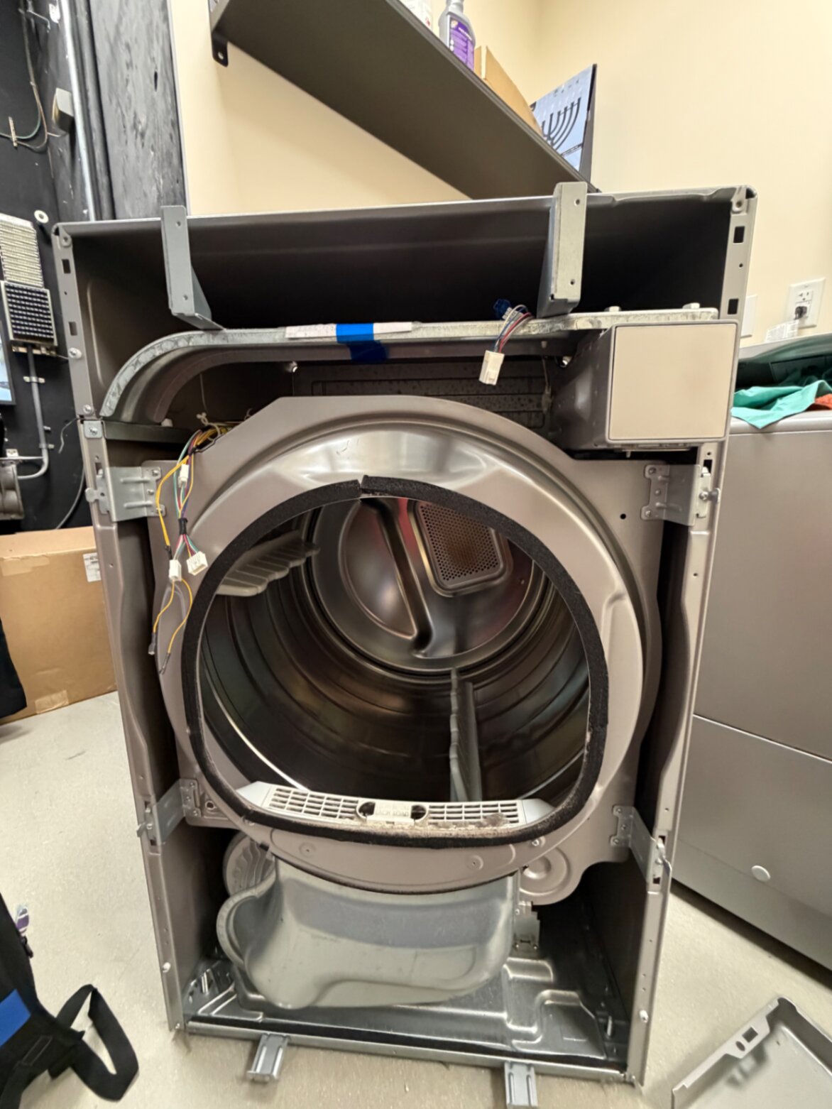 Commercial dryer cabinet opened for service and inspection